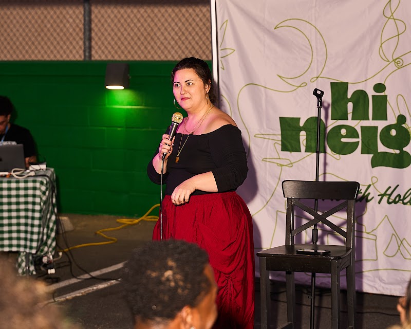 A performer on the mic at a Hi Neighbor event