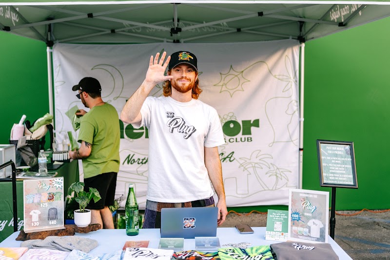 A guest waving at the Hi Neighbor tent