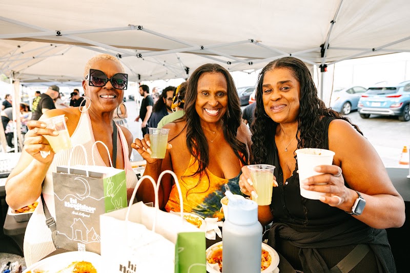 Guests with drinks at a Hi Neighbor event